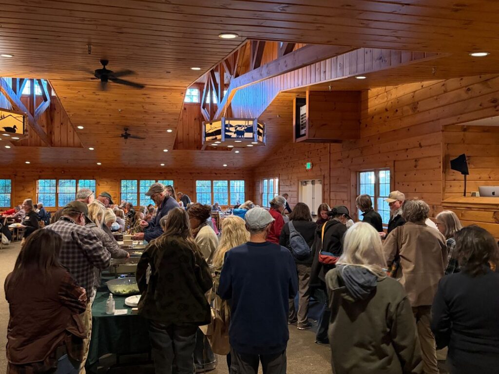 a group of people in line at a buffet