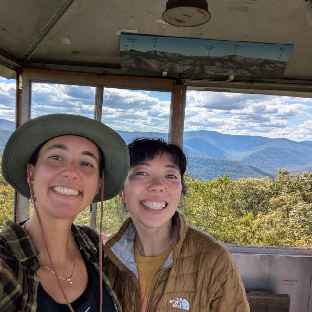 two people take a selfie in a fire tower cab