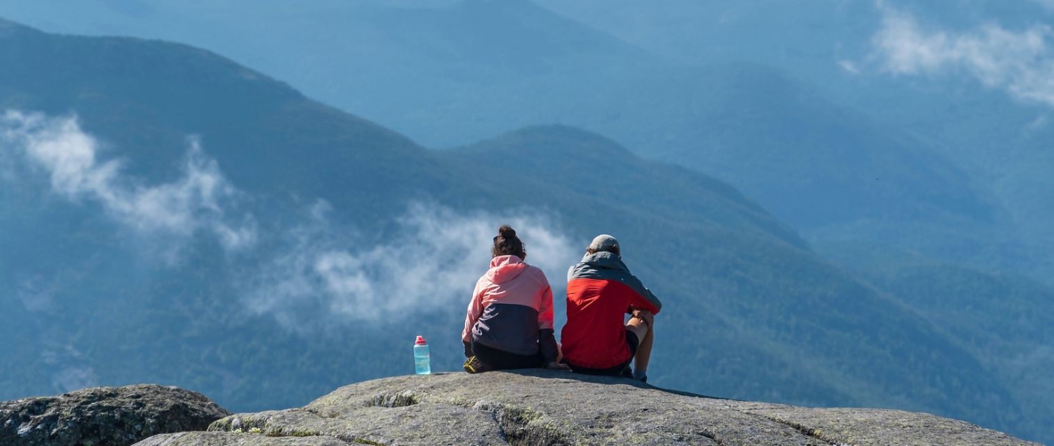 two hikers sitting on adirondack summit