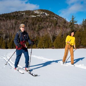 two skiers on heart lake with mount jo in background
